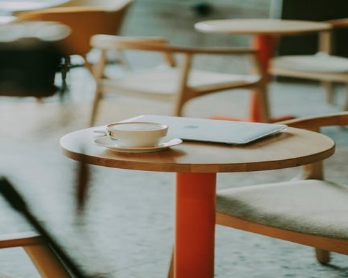 A quiet cafe table with a laptop, suitable for a meeting